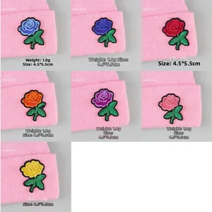 Detail of rose embroidery patches on knitted hats available in seven different colors