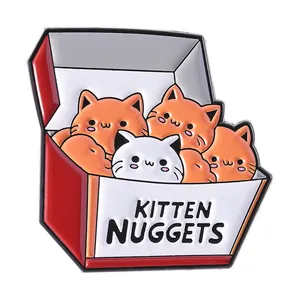 Funny enamel pin featuring kitten nuggets in a red fast food box on white background