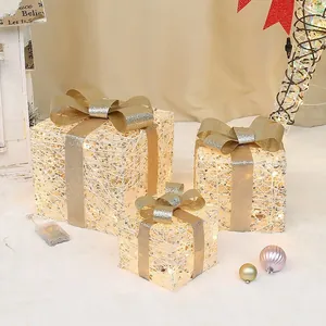 Three-piece set of cream LED glowing Christmas gift boxes with champagne gold bows