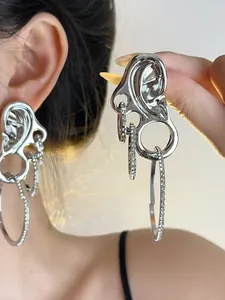 Macro detail of silver abstract art earrings with sparkling diamond-set concentric rings