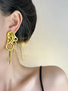Detail of vintage gold drop earrings with micro-pave crystals and elegant tassel chains