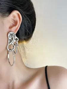 Close-up of silver multilayer hoop earrings with pavé zircons on a model side view