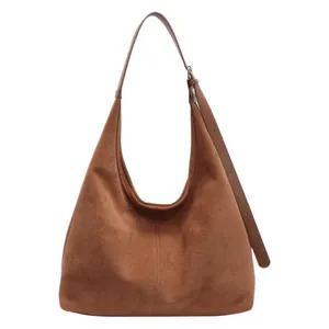 Brown faux suede hobo shoulder bag with large capacity and adjustable strap on white background