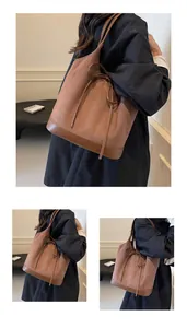 Detail of vintage brown tote bag showing suede and leather textures with bow drawstring