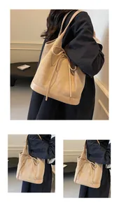 Detailed close-up of beige suede tote bag showing soft texture and decorative bow knot