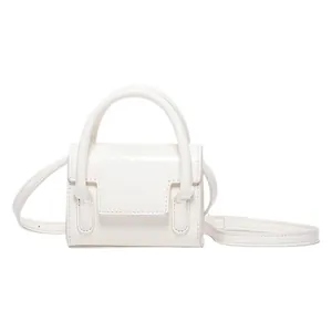 Mini white faux leather square handbag with top handle and crossbody strap for women