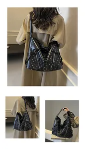 Detailed view of polka dot hobo bag with metal zippers and adjustable shoulder strap