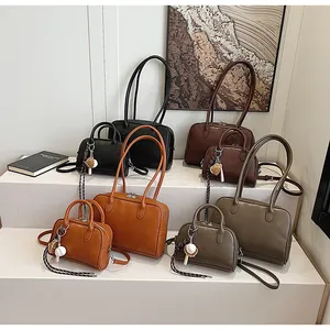 Macro view of retro faux leather tote bags in various colors and sizes on white stands