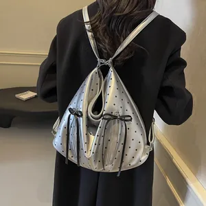 Polka dot silver metallic backpack with black bows and spacious dual zip pockets
