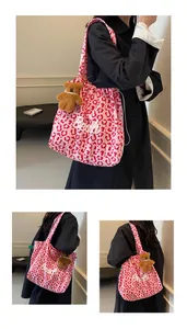 Detail of pink leopard print canvas tote bag with drawstring closure and plush bear charm