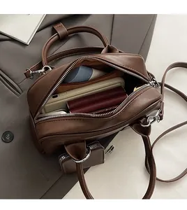 Detail view of the spacious interior of this brown PU leather crossbody square bag