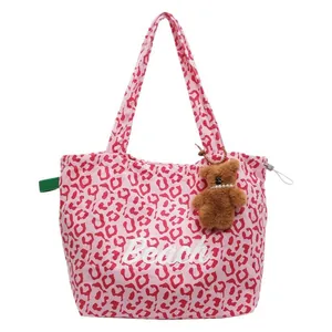 Pink leopard print canvas tote bag with Beach text and a plush bear pendant charm