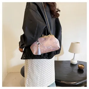 Detailed macro view of retro Chinese style brocade bag with floral patterns and tassel