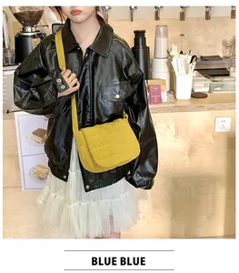 Crossbody shot of a bright yellow quilted puffer bag with an adjustable strap