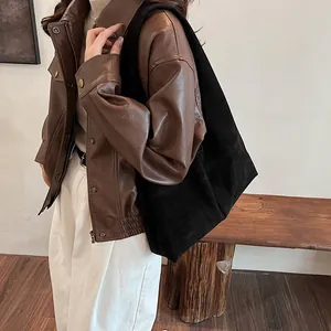 Vintage brown suede large tote bag styled with a leather jacket in a fashion look