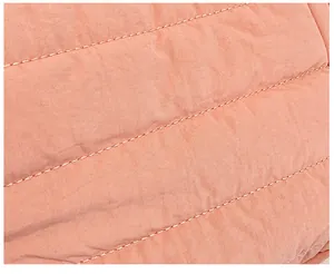 Macro detail of parallel double stitching on quilted pink fabric for shoulder bag