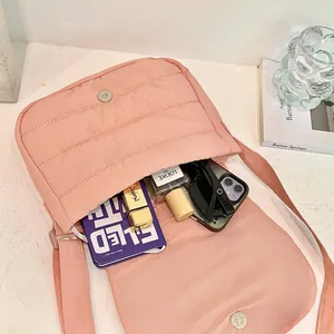 Pink quilted shoulder bag showing interior capacity with cosmetics and daily essentials