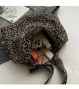 Detailed view of the leopard print tote bag interior showing large capacity and zipper pocket