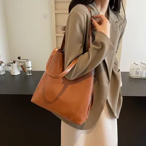 Large caramel brown faux leather tote bag with shoulder straps for women in urban style