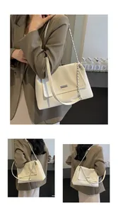 Detail of cream patent leather shoulder bag with metal chain strap and MIKAXIOL nameplate