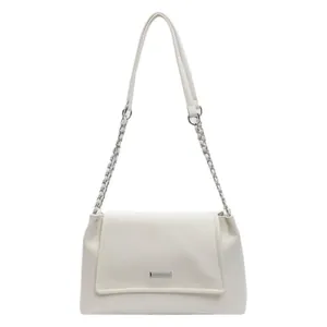 Minimalist beige underarm bag with double straps and silver metal logo on a clean white background