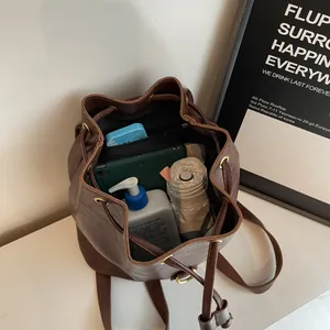Interior view of vintage brown bucket backpack showing large capacity and drawstring detail