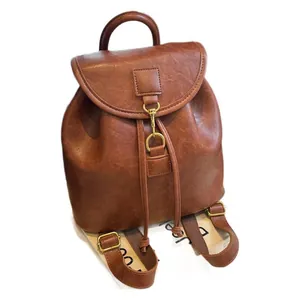 Brown vintage PU leather backpack with gold ring hardware and drawstring closure