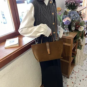 Vintage brown suede tote bag with leather handles and strap for fall fashion