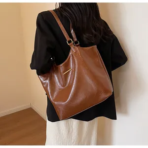 Brown vintage oil wax leather tote bag shown on model for a classic commuter style look