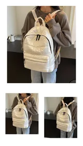 Detailed view of the white quilted padded backpack with metallic waterproof finish for women