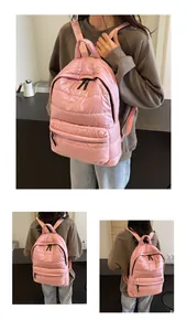 Detail of pink padded puffer backpack featuring quilted texture and adjustable straps
