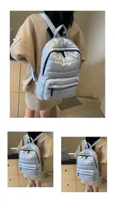 Detailed views of the light blue quilted backpack showing puffer texture and zip pockets
