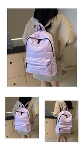 Detail of lavender quilted padded backpack showing soft nylon texture and stitching