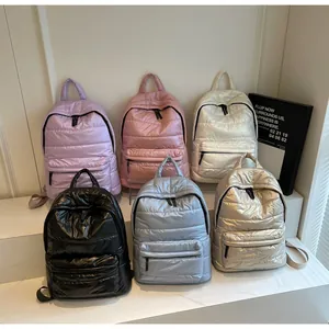 Detailed showcase of quilted puffer backpacks in six metallic colors with zip pockets