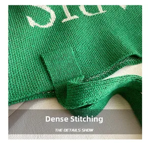 Detail van groene gebreide draagtas met versterkte stiksels en letterpatronen