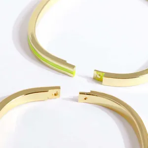 18K gold plated bangle with green enamel finish and polished metallic texture