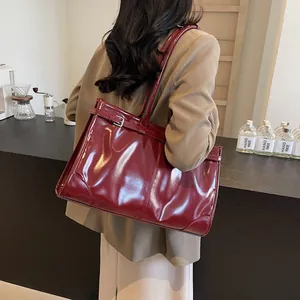 Large burgundy oil wax leather tote bag with glossy finish and silver buckle detail