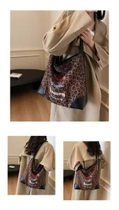 Detail of leopard print tote bag with cartoon dachshund illustration and black shoulder strap