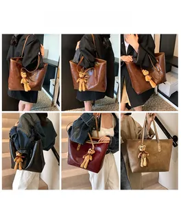 Large tote bags in brown, black, and burgundy with cute bear charms on model