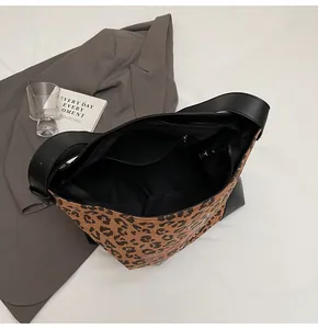 Internal view of leopard print shoulder bag showing zipper closure and spacious lining
