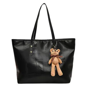 Large black tote bag with square panel texture and cute bear charm for daily commute
