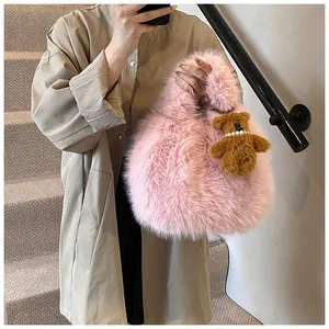 Pink faux fur tote bag detail with cute brown teddy bear charm and pearl necklace