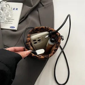 Leopard print crossbody phone bag with drawstring closure and interior capacity view