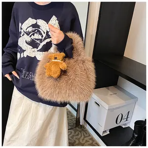 Detail of plush brown cloud tote bag featuring a cute teddy bear charm with pearls