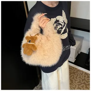 Detail of beige fluffy cloud tote bag with cute teddy bear charm and soft fur texture
