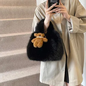 Chic black faux fur tote bag with a plush bear charm shown in a minimalist street style