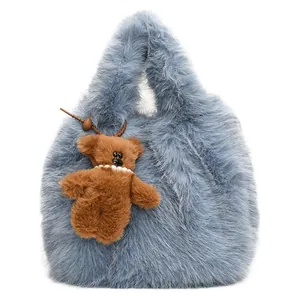 Blue fluffy faux fur cloud tote bag with cute brown plush bear charm for autumn fashion