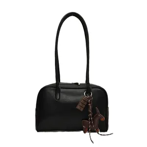 Retro black leather bowling bag for women with chocolate and pony charms detail
