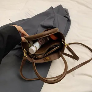 Retro dark brown pebbled leather bucket bag with top handle and spacious interior