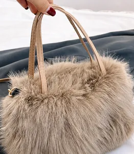 Detail of plush faux fur tote bag in beige with soft texture and golden metal rings
